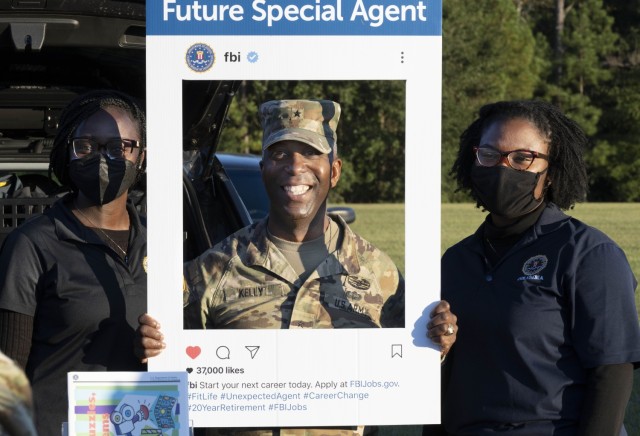Brig. Gen. Jason E. Kelly, Fort Jackson and Army Training Center commanding general, poses in a sign showing him as a furture special agent with the Federal Bureau of Investigation Oct. 4 during the National Night Out event. The event brought together federal, state and local law enforcement agencies to meet with community members to enhance their relationship with the community. The FBI was one of many agency represented at the event.