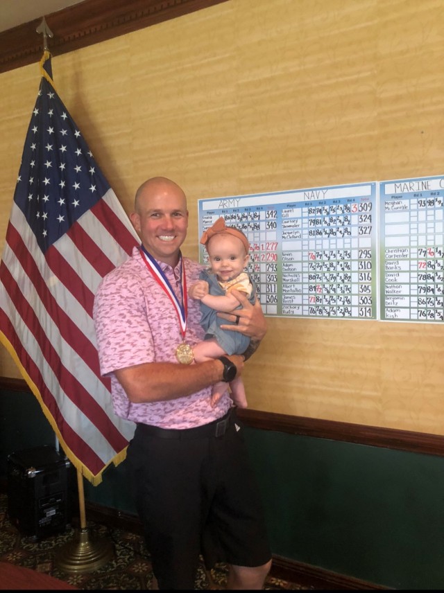 SSG Austin Teal, holding his infant daughter Palmer, tied for 10th at the Armed Forces Championships in Fort Belvoir, Virginia.