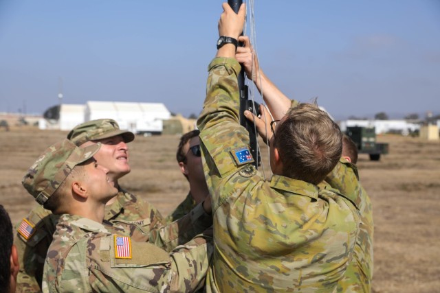 U.S. and Australian Soldiers set up the Terrestrial Transmission Line of Sight Radio System.