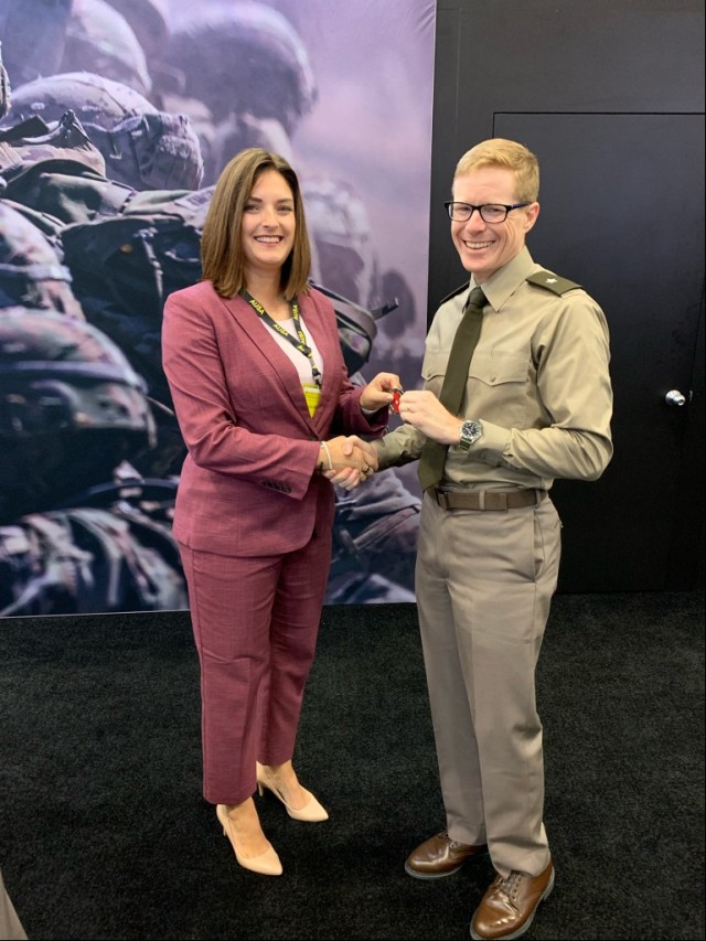 (From right) U.S. Army Security Assistance Command Commanding General Brig. Gen. Brad Nicholson recognizes Security Assistance Liaison Officer (SALO) Program Manager Terra Good for her hard work and dedication at AUSA 2022. Good and SALOs attended to highlight partnership building at the annual event in Washington D.C. Oct. 10-12.