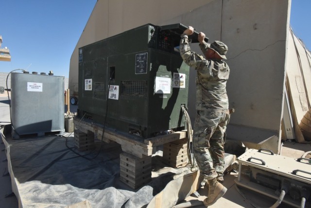 Minnesota Army National Guard Master Sgt. Lee Christopherson checks the power load on a ramp generator adjacent to the airfield at Al Asad Air Base, Iraq, Sept. 27, 2022. Christopherson is Base Operating Support-Integrating logistics and mobility noncommissioned officer in charge with 347 Regional Support Group, Combined Joint Task Force - Operation Inherent Resolve. (Minnesota Army National Guard photo by Staff Sgt. Sirrina E. Martinez)
