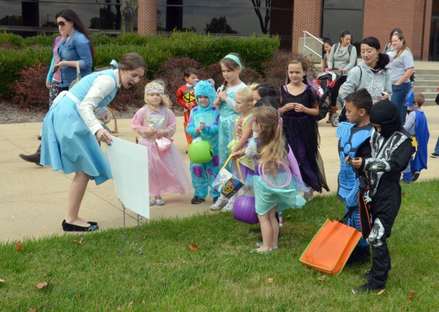 Going from station to station, Belle (Lacie McMillin), helps children read “Room on the Broom” before heading inside for trick-or-treating with the library staff during the Bruce C. Clarke Library’s 2016 Halloween StoryWalk. This year, attendees will read “How to Scare a Ghost” by Jean Reagan. 