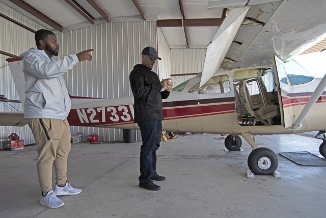 Ronald Williams, a certified flight instructor available for hire here (left), discusses a pre-flight checklist with 1st Lt. Joshua Hood Friday at the Waynesville-St. Robert Regional Airport – also known as Forney Airfield. Hood is a Captains Career Course student here, who is working toward a pilot’s license in his spare time. 