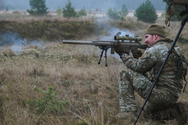 Staff Sgt. Chris Smith fires from a hasty kneeling position during the enhanced Forward Presence Battle Group Latvia International Sniper Competition at Camp Adazi, Latvia, Nov. 16, 2021. The LISC was created to bring sniper teams from across NATO together to share knowledge and engage in challenging, friendly competition. (U.S. Army National Guard photo by Sgt. Remi Milslagle)