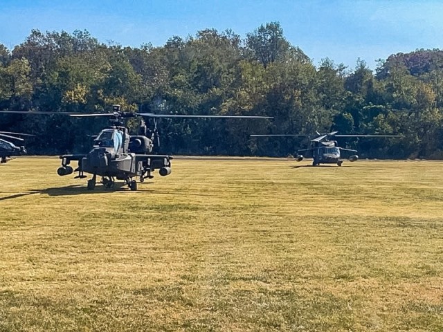One AH-64 Apache and one UH-60 Blackhawk stage in preparation for supporting the flyover during the National Anthem 