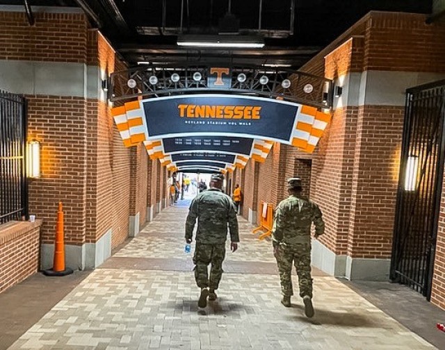 Maj. Jared Maxwell (right), a 2006 graduate of Tennessee walks through the tunnel to be escorted onto the field to be recognized for his efforts in supporting the flyover.