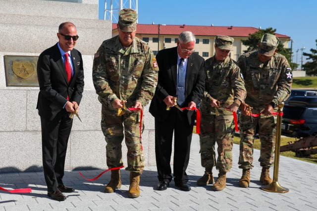 U.S. SES Charles Bowery Jr., U.S. Army Lt. Gen. Bill Burleson, retired U.S. Army Col. William Alexander,  U.S. Army Brig. Gen. Lori Robinson, and Command Sgt. Maj. Kenneth Franco, cut the ribbon in honor of the grand opening of the 2nd Infantry Division 8th Army Korean Theater of Operations Museum at Camp Humphreys, South Korea on Oct. 19, 2022. The museum is free for visitors. (U.S. Army photo by Spc. Alison Strout)