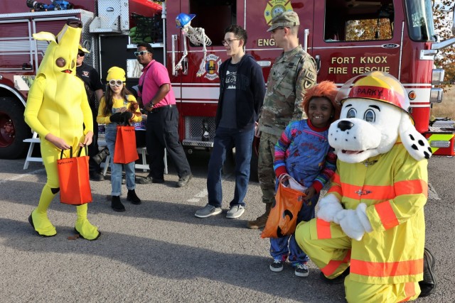 A Knox Hills resident poses with Sparky from the Fort Knox Fire Department at the Lendlease-hosted Festa-Boo fall festival Oct. 21, 2022, honoring Resident Appreciation Month.