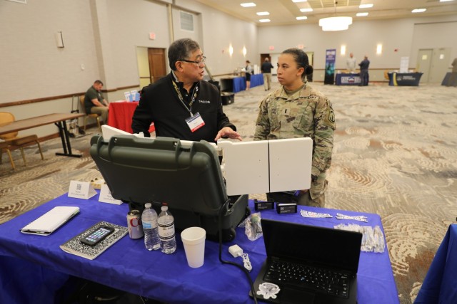 1st Lt. Hannah Foster, a Soldier assigned to the 385th Military Police Battalion, inspects equipment during a technology expo, Oct. 20 at Club Stewart on Fort Stewart. Events like the technology expo provide Soldiers knowledge and understanding of cutting-edge technology that might make its way into the hands of Soldiers in the future.  (U.S. Army photo by Pfc. Dustin Stark, 50th Public Affairs Detachment)