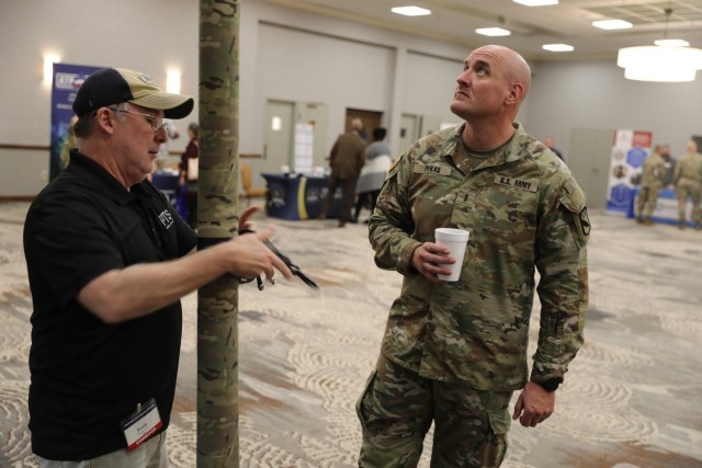 A vendor presents a product to Chief Warrant Officer 3 Justin Pekas, a Soldier assigned to the 103rd Intelligence and Electronic Warfare Battalion, during a technology expo, Oct. 20 at Club Stewart on Fort Stewart. The tech expo provided vendors the opportunity to showcase their company&#39;s products to Soldiers and leaders in 3rd ID as the division undergoes modernization efforts. (U.S. Army photo by Pfc. Dustin Stark, 50th Public Affairs Detachment)