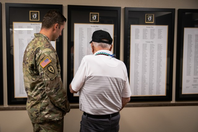 Private 2nd Class (ret.) Warren H. Schuster views a list of fallen warriors with a Soldier from 2nd Battalion, 35th Infantry Regiment, 3rd Infantry Brigade Combat Team, 25th Infantry Division, during his visit to Schofield Barracks, Hawaii, Oct. 21, 2022. Accompanied by his three daughters, 91-year-old Schuster visited the 25th Inf. Div. and his prior unit more than seven decades after fighting and subsequently  being injured in the Korean War. (U.S. Army photo by Sgt. Rachel Christensen/28th Public Affairs Detachment)