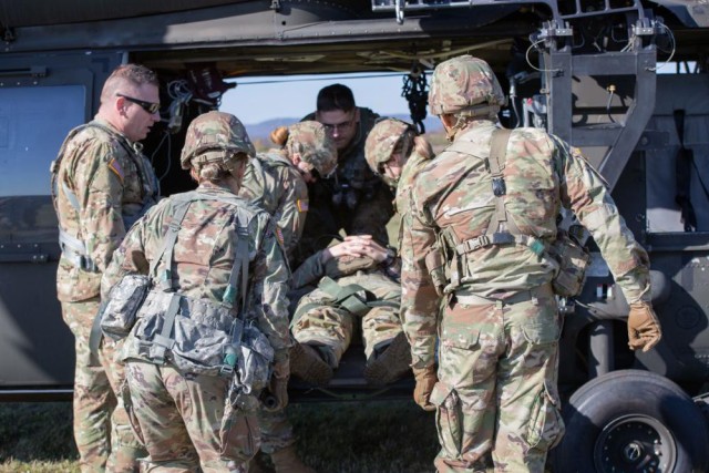 New York Army National Guard Soldiers assigned to the 466th Area Medical Company load a gurney onto a Black Hawk helicopter during a combined training event with Soldiers with Charlie Company, 1st Battalion, 171st General Support Aviation Regiment, in Queensbury, New York, Oct. 22, 2022. (Pfc. Jean Sanon)
