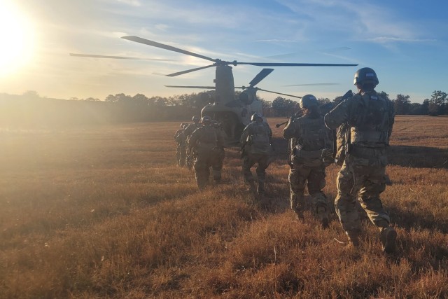 Trainees with Company E, 701st Military Police Battalion board a C-47 Chinook helicopter Oct. 20 at the Training Area 401 landing zone as part of the final field training exercise of the basic combat training phase of one station unit training at Fort Leonard Wood. 