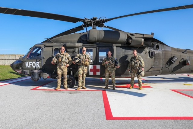 Left to right, U.S. Army Sgts. Jon Atcitty and Jacob Anderson, inflight paramedics; Chief Warrant Officer 3 Robert Anderson, pilot in command; and Chief Warrant Officer 2 John Carey, second pilot in command, all assigned to Charlie Company, 2nd Battalion, 149th Aviation Regiment, Arizona National Guard, in front of their UH-60 Black Hawk medevac helicopter at Camp Bondsteel, Kosovo, Oct. 21, 2022. Their unit is supporting ongoing operations in Kosovo Force’s Regional Command-East. 