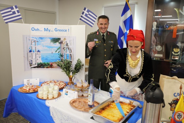 Security Assistance Liaison Officer Col. Athanasios Natsios and wife Christina prepare to serve their fellow USASAC teammates during the 2022 International Buffet Oct. 20, 2022. The International Buffet is a celebration in honor of the 13 home countries of USASAC’s SALO officers. SALOs like Natsios streamline logistics and monitor Foreign Military Sales cases for their militaries. 