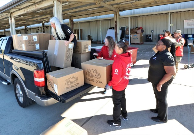 Volunteers with the Fort Knox Red Cross Warrior Warehouse load boxes of donated clothing, bedding and other items onto a truck Oct. 27, 2022, for the Elizabethtown Community and Technical College Family Scholar House.