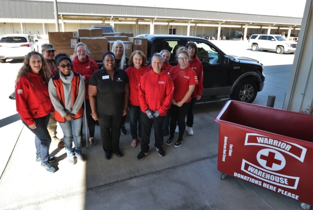 Volunteers with the Fort Knox Red Cross Warrior Warehouse load boxes of donated clothing, bedding and other items onto a truck Oct. 27, 2022, for the Elizabethtown Community and Technical College Family Scholar House.