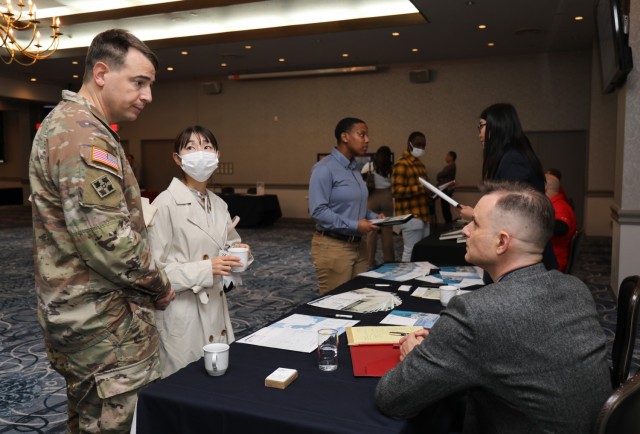 Maj. Tom Douglas, left, who is assigned to the U.S. Army Japan G-4 office, and his wife, Megumi, attend a hiring expo at the Camp Zama Community Club, Japan, Oct. 28, 2022. The hiring expo was part of a Retiree Appreciation Day event that had several booths with representatives from on- and off-post organizations seeking new applicants.