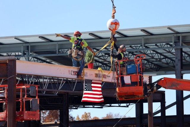 Contractor bolts last steel beam to new Van Voorhis Elementary School