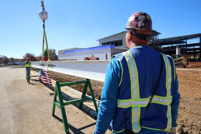 Contractor bolts last steel beam to new Van Voorhis Elementary School