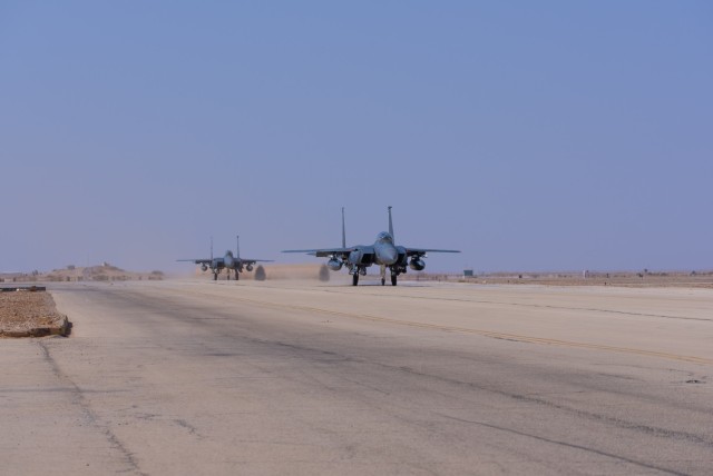 U.S. Air Force F-15E Strike Eagles with the 335th Expeditionary Fighter Squadron taxi on a runaway