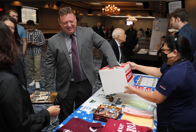 Joe Brown, a retired Coast Guardsman, participates in a prize giveaway at the AAFES booth during a hiring expo at the Camp Zama Community Club, Japan, Oct. 28, 2022. The hiring expo was part of a Retiree Appreciation Day event that had several booths with representatives from on- and off-post organizations seeking new applicants.