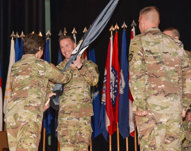 Lt. Gen. Maria Barrett, U.S. Army Cyber Command commanding general, passes the guidon of the Cyber Protection Brigade to Col. Christopher Stauder, incoming CPB commander, during a change of command ceremony at Fort Gordon, Georgia, Oct. 27, 2022....