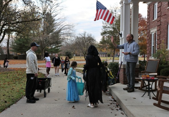 Commanding General of U.S. Army Recruiting Command and Fort Knox Maj. Gen. Johnny Davis waves to trick-or-treaters as he hands out candy Oct. 31, 2022.