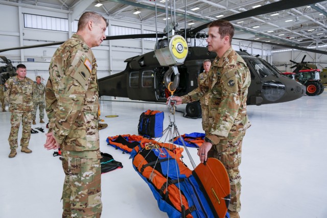 Army Gen. Daniel Hokanson, chief, National Guard Bureau, left, talks with Staff Sgt. Jeremy Hubbard, a crewmember flight instructor and Black Hawk mechanic, about the equipment the Colorado National Guard uses during airlift rescues on a visit to the Colorado National Guard's High-altitude Army National Guard Aviation Training Site, or HAATS, in Gypsum, Colorado, Oct. 16, 2022. HAATS is facilitated by Colorado Guardsmen and designed to train military pilots from any branch in power management and operating in high-altitude environments. (U.S. Army National Guard photo by Sgt. 1st Class Zach Sheely)