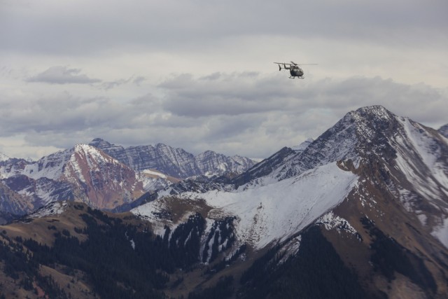 An LUH-72 Lakota helicopter is flown above mountains near Gypsum, Colorado, home of the Colorado National Guard&#39;s High-altitude Army National Guard Aviation Training Site, or HAATS, Oct. 16, 2022. Army Gen. Daniel Hokanson, chief, National...