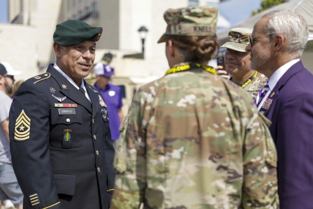 .S. Army Sgt. Maj. Antonio Gonzalez (left) converses with Army leaders from the 1st Infantry Division and Kansas State University during the KSU Fort Riley Day event, September 17, 2022. He later received the Medal of Military Excellence and a President Emeritus Myers coin presented by Kansas State University’s President, Dr. Richard Linton, in a pre-game ceremony.