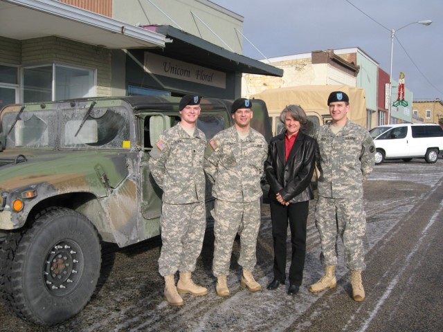 Maj. Shawn Atkins, Maj. David Atkins and Maj. Casey Atkins, pose for a photo while at an event in Hill City, Kansas. The brothers all serve in the Kansas National Guard and have seen duty overseas, but never together. 