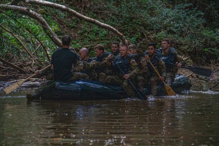 U.S. Army Soldiers participating in Jungle School perform waterborne operations at Schofield Barracks, Hawaii, on Oct. 15, 2022. During Waterborne day at Jungle School, students learn how to correctly and safely cross a water obstacle in the jungle using one rope bridge, poncho ruck rafts and zodiacs.
