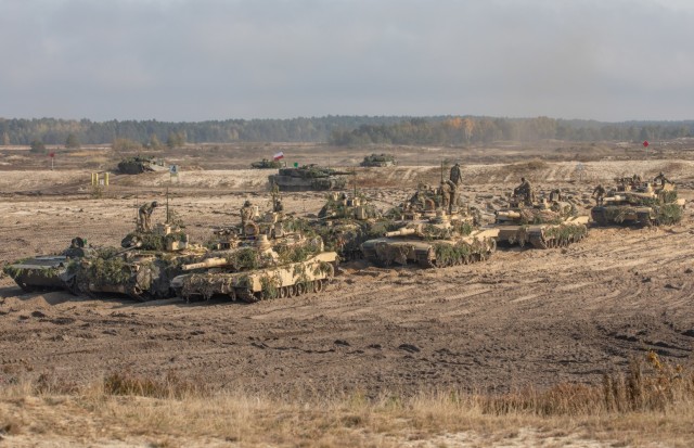 U.S. Army Soldiers assigned to 1st Battalion, 68th Armor Regiment, 3rd Armored Brigade Combat Team, 4th Infantry Division (3-4 ABCT) maneuver M1A2 Abrams tanks alongside Polish armored personnel carriers with soldiers assigned to the 11th Armored Lubuska Cavalry Division during Borsuk 2022 live-fire exercise at Nowa Deba, Poland, Oct. 13, 2022.  Poland is proudly working alongside 1st Infantry Division, other NATO allies and regional security partners to provide combat-credible forces to V Corps, America&#39;s forward deployed corps in Europe.