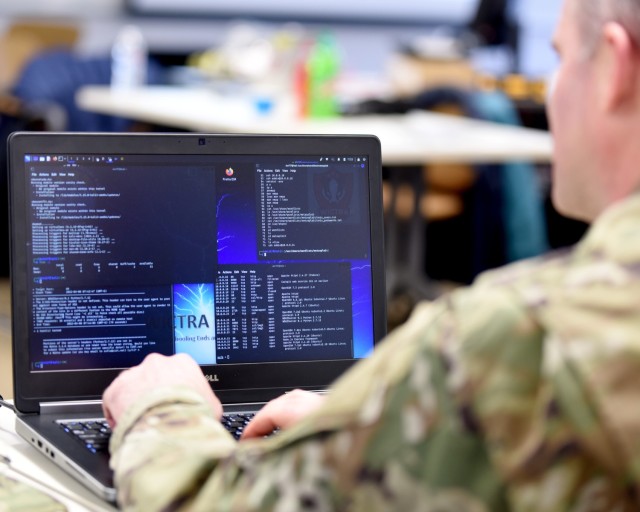 U.S. Air Force Capt. Shannon Bender, 272nd Cyber Operations Squadron, 110th Wing, Michigan Air National Guard, reviews computer information during a cyber warfare training event, Camp Grayling Joint Maneuver Training Center, Michigan, March 8,...