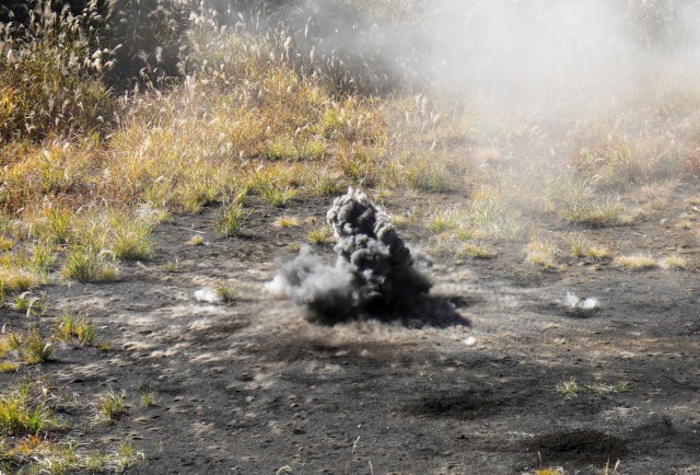 A hand grenade explodes on a small range at Combined Arms Training Center Camp Fuji, Japan, Nov. 2, 2022. About 30 Soldiers from the 35th Combat Sustainment Support Battalion threw grenades during a week of live-fire training that also included small arms and crew-served weapons to better prepare the unit for possible base defense missions. 
