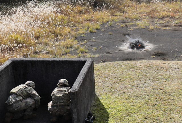 A hand grenade explodes on a small range at Combined Arms Training Center Camp Fuji, Japan, Nov. 2, 2022. About 30 Soldiers from the 35th Combat Sustainment Support Battalion threw grenades during a week of live-fire training that also included small arms and crew-served weapons to better prepare the unit for possible base defense missions. 