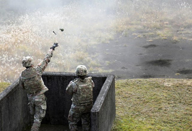 A Soldier assigned to the 35th Combat Sustainment Support Battalion throws a hand grenade into a small range at Combined Arms Training Center Camp Fuji, Japan, Nov. 2, 2022. About 30 Soldiers from the battalion threw grenades during a week of live-fire training that also included small arms and crew-served weapons to better prepare the unit for possible base defense missions. 
