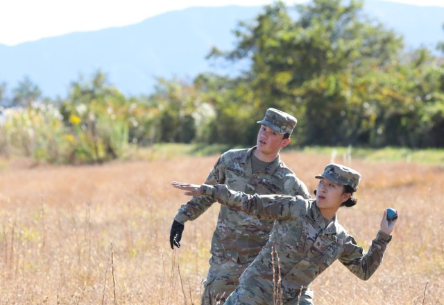 Sgt. Nhien Nguyen and Pfc. William Desautels, both assigned to the 35th Combat Sustainment Support Battalion, practice the procedures of throwing a hand grenade during training at Combined Arms Training Center Camp Fuji, Japan, Nov. 2, 2022. About 30 Soldiers from the battalion threw grenades during a week of live-fire training that also included small arms and crew-served weapons to better prepare the unit for possible base defense missions. 