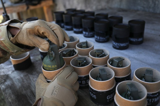 Staff Sgt. Jarred Webb, an ammunitions specialist with the 35th Combat Sustainment Support Battalion, takes hand grenades out of their cardboard canisters during training at Combined Arms Training Center Camp Fuji, Japan, Nov. 2, 2022. About 30 Soldiers from the battalion threw the grenades during a week of live-fire training that also included small arms and crew-served weapons to better prepare the unit for possible base defense missions. 
