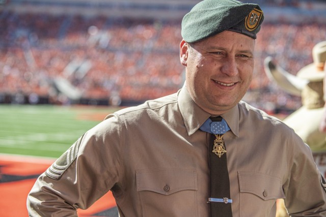 Master Sgt. Earl Plumlee, a Medal of Honor recipient, takes part in pre-game activities at the Oklahoma State University homecoming football game in Stillwater, Oklahoma, Oct. 22, 2022. Plumlee, a native Oklahoman, toured his home state Oct. 18-22. (Oklahoma National Guard photo by Sgt. Anthony Jones)