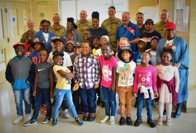 Signal Soldiers from Fort Gordon pose for a picture with A. Dorothy Hains Elementary School staff members, several who are veterans, and second grade students, on Nov. 10.