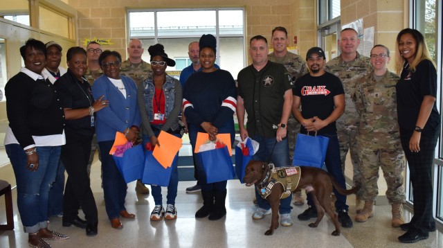 De Neiya Goodly (far right), chief of the Information Signal and Technology Branch, U.S. Army Signal School, along with Soldiers from Fort Gordon, pose for a picture with A. Dorothy Hains Elementary School staff members, several who are veterans, on Nov. 10.