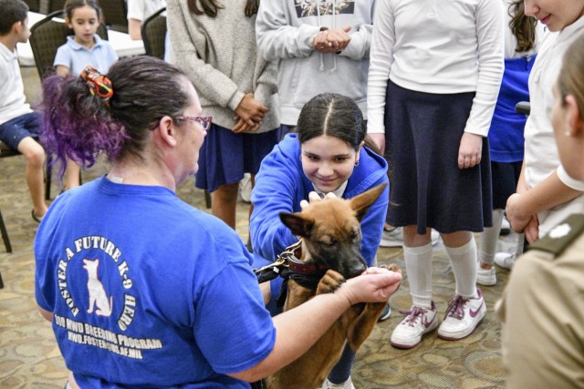 As part of the U.S. Medical Center of Excellence’s Veterans Day Presentation, at the Torah Academy of San Antonio, students met a military working dog in-training named “EEphy” courtesy of Lora Harrist from the Military Working Dog Foster Volunteer program. During the one-hour hands-on presentation, the students, ranging from kindergarten to 7th grade also got to experience what it is like to have a job in the Army Veterinary Corps like examining kosher Army Meals-Ready-to-Eat using methods similar to the Corps’ food inspectors and even learned how to dress a notional wound on the Diesel Canine Simulator.
