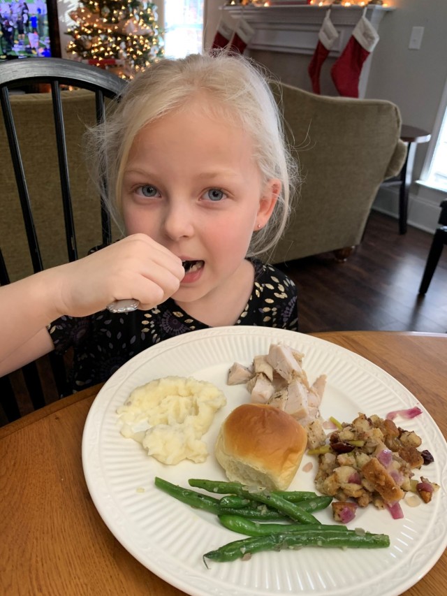 Turkey, stuffing and potatoes, oh my! Author Jenn DeHaan’s daughter Ella (6) enjoys her Thanksgiving dinner at their Columbus, Georgia home in 2019 while stationed at Fort Benning.