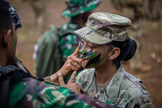 SFAB Advisor prepares camouflage with Indonesian Soldiers