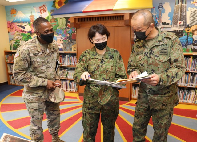 Command Sgt. Maj. Justin E. Turner, left, senior enlisted leader of U.S. Army Garrison Japan, joins Warrant Officer Masanobu Murawaki, right, the sergeant major of the Japan Ground Self-Defense Force, as he tours the Camp Zama Library during his visit to Camp Zama, Japan, Aug. 16, 2022. Turner recently spoke about his time in Japan before he relinquishes his responsibility to Command Sgt. Maj. David Rio during a ceremony Dec. 2, 2022. 