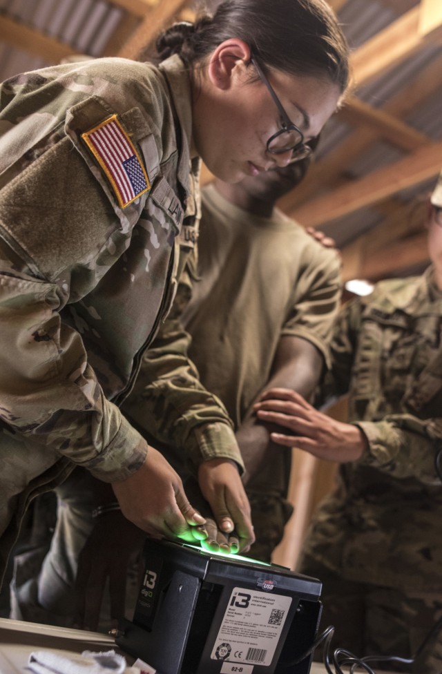 Spc. Emily Lam, an internment resettlement specialist with the 357th Military Police Company runs a fingerprint scan on a prisoner utilizing the Biometrics Automated Toolset System, which recognizes insurgents and unwanted individuals in an area, as part of Pacific Warrior.  Soldiers with the 11th Military Police Brigade spent two weeks in Fort Hunter Liggett, California training on basic Army Warrior Tasks, weapons qualification, military police specific tasks, and support tasks.