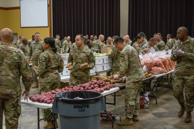 Soldiers, veterans, and volunteers distribute Thanksgiving care packages to families in need