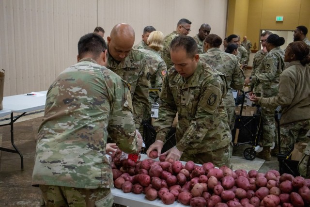 Soldiers, veterans, and volunteers distribute Thanksgiving care packages to families in need